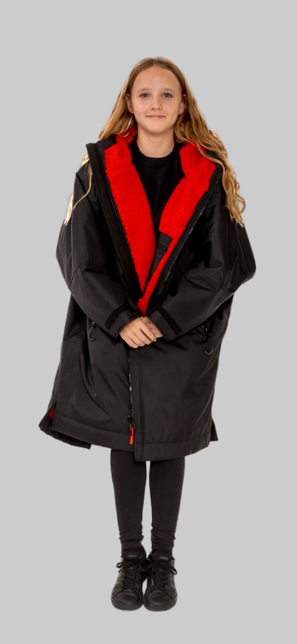 Model wearing RuggaRobe black change robe with red fleece interior on grey background