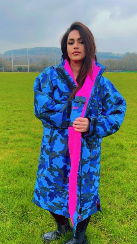 Model wearing RuggaRobe blue camo change robe with grey fleece interior on on a sportsfeild
