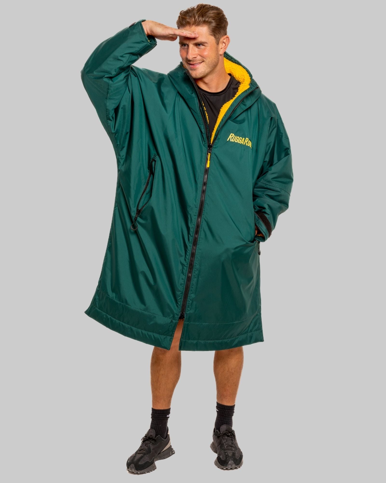 Person wearing a green changerobe with a ruggarobe logo on a grey background