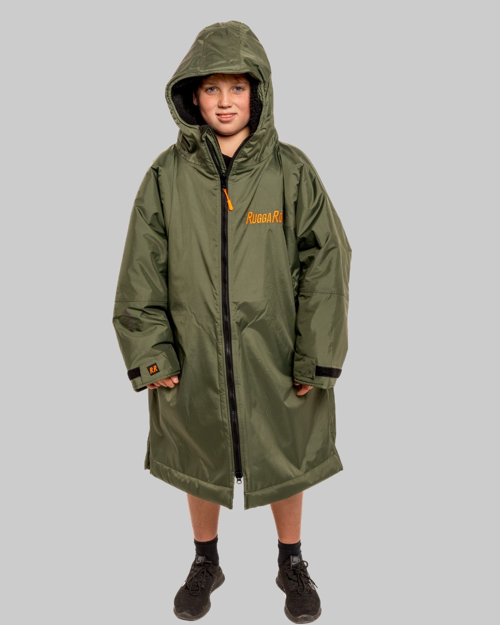 Model wearing RuggaRobe green change robe with black fleece interior on grey background