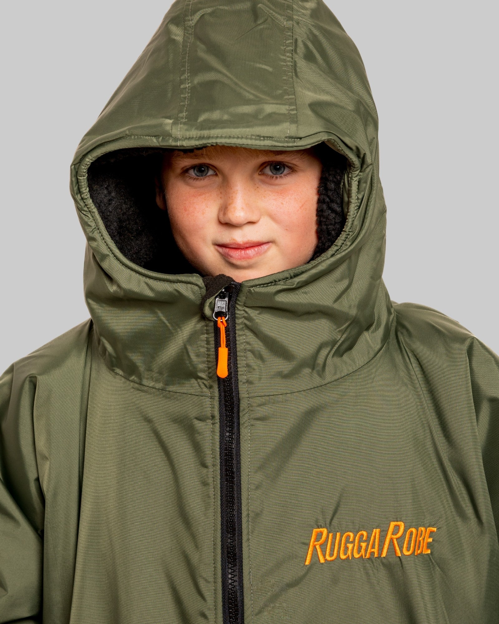 Child wearing a green hooded jacket with 'Rugga Robe' branding on a gray background