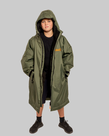 Model wearing RuggaRobe green change robe with black fleece interior on grey background