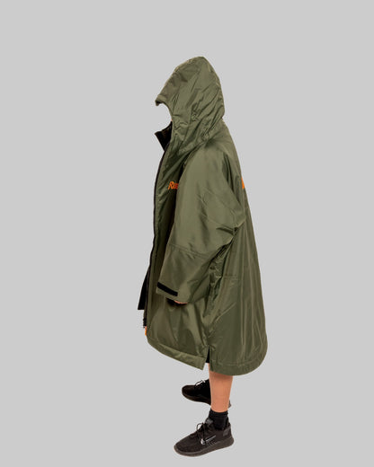 Model wearing RuggaRobe green change robe with black fleece interior on grey background