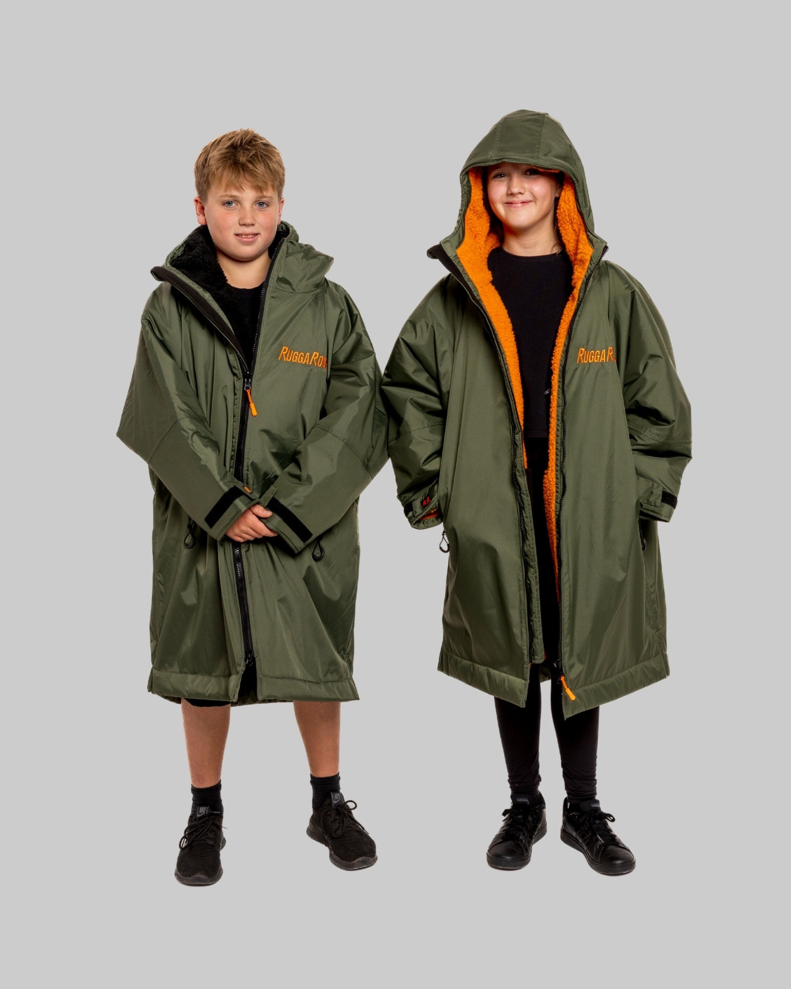 Two people wearing green hooded ruggarobes, with 'RuggaRobe' branding.