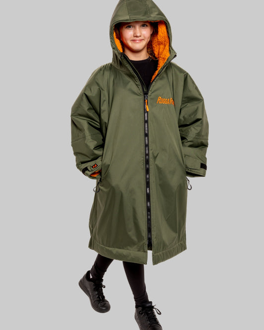 Model wearing RuggaRobe green change robe with orange fleece interior on grey background
