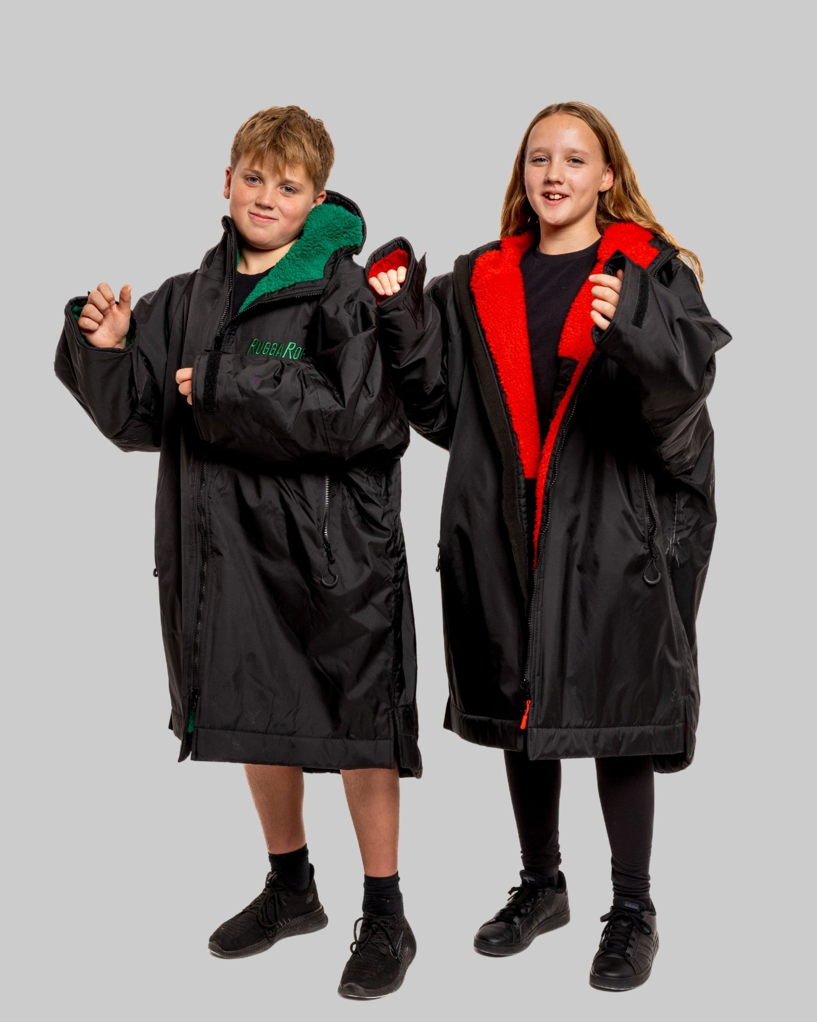 Model wearing RuggaRobe black change robe with red fleece interior on grey background
