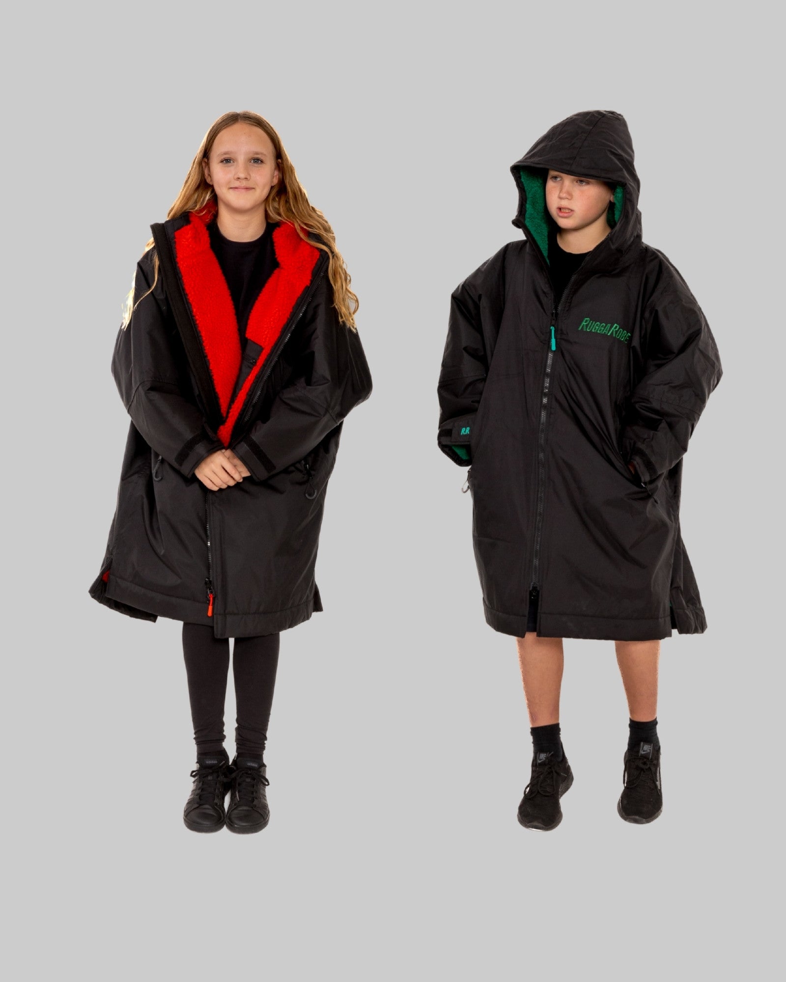 Model wearing RuggaRobe black change robe with red fleece interior on grey background