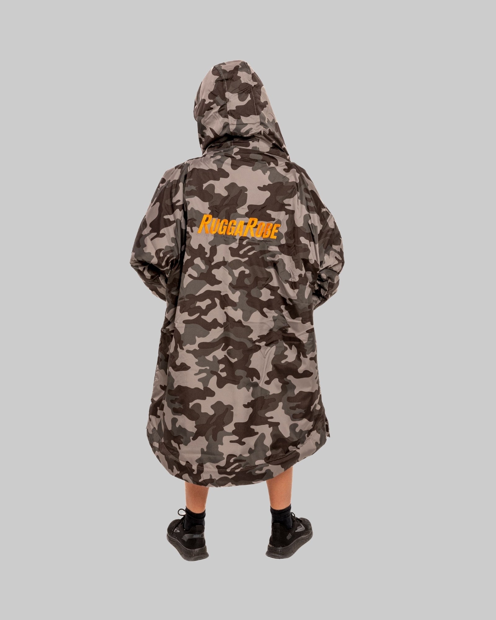 Model wearing RuggaRobe grey camo change robe with orange fleece interior on grey background