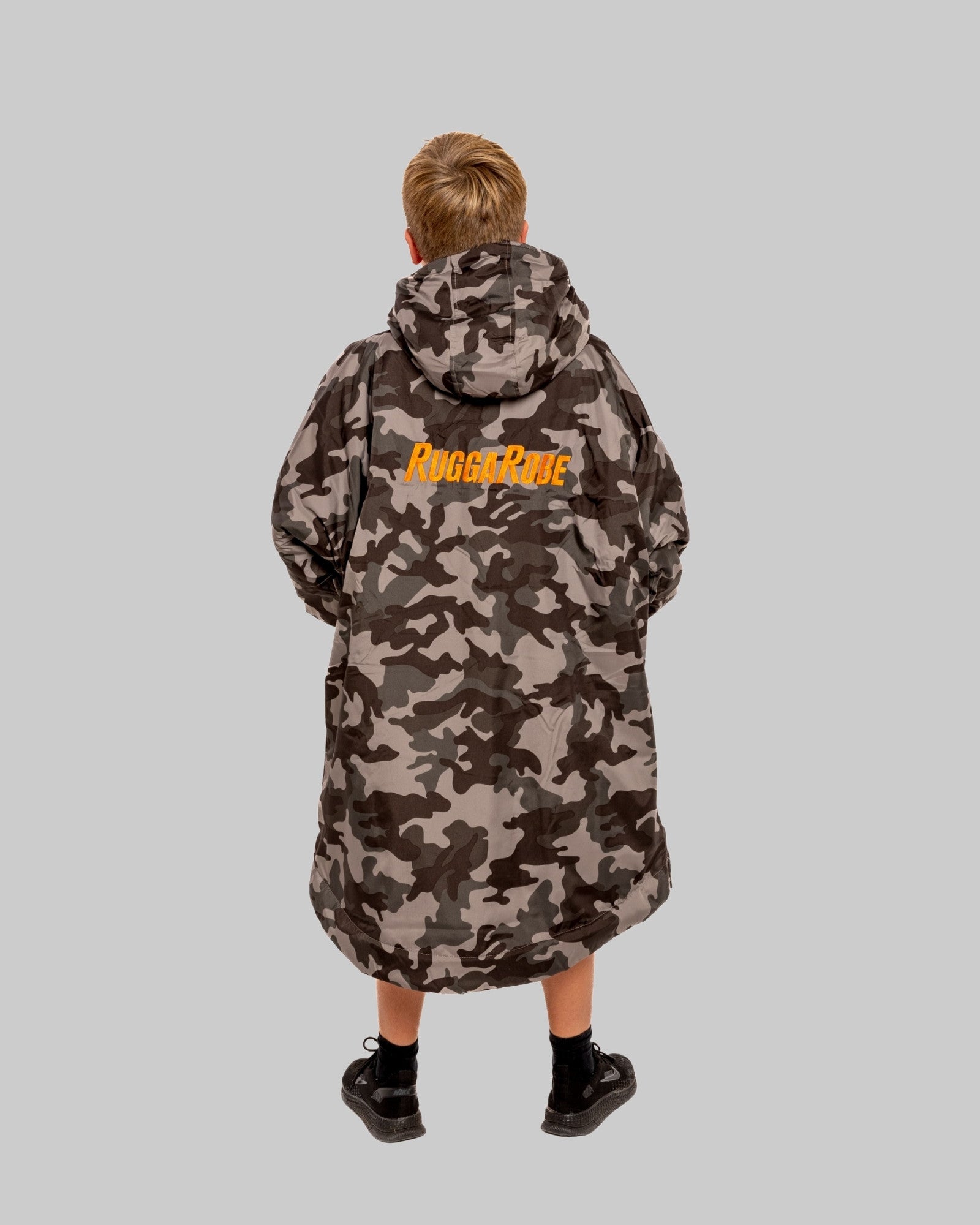 Model wearing RuggaRobe grey camo change robe with orange fleece interior on grey background