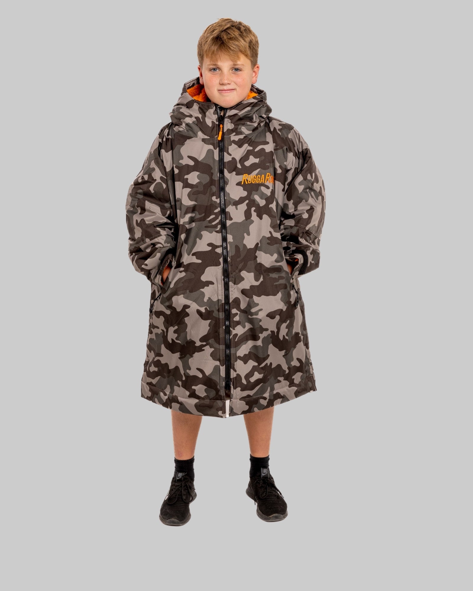 Model wearing RuggaRobe grey camo change robe with orange fleece interior on grey background