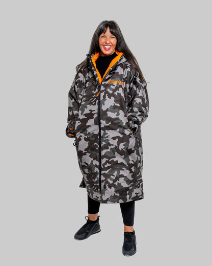Model wearing RuggaRobe grey camo change robe with orange fleece interior on grey background