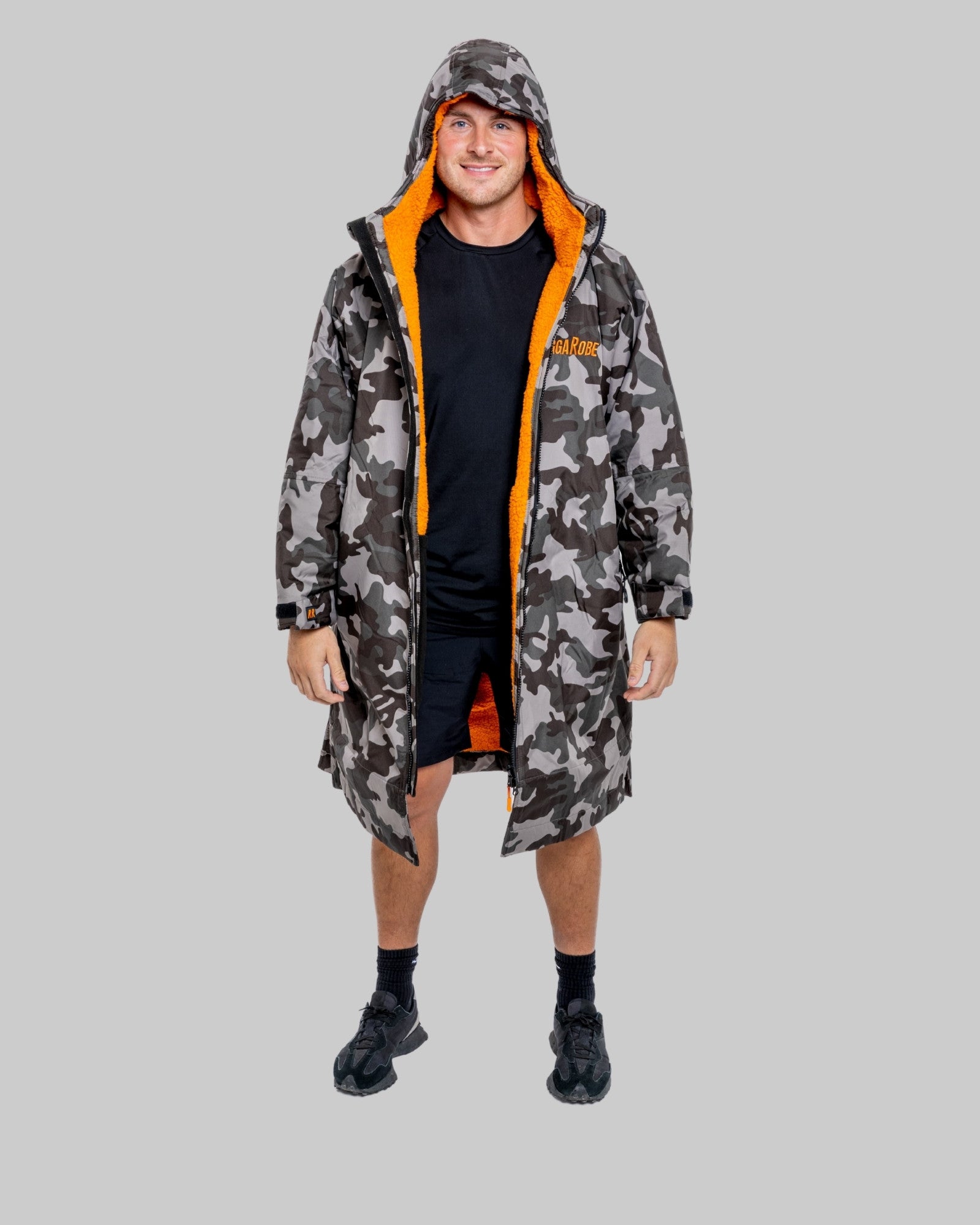 Model wearing RuggaRobe grey camo change robe with orange fleece interior on grey background