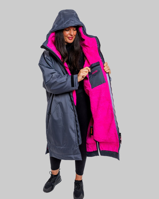 Model wearing RuggaRobe slate grey change robe with pink fleece interior on grey background