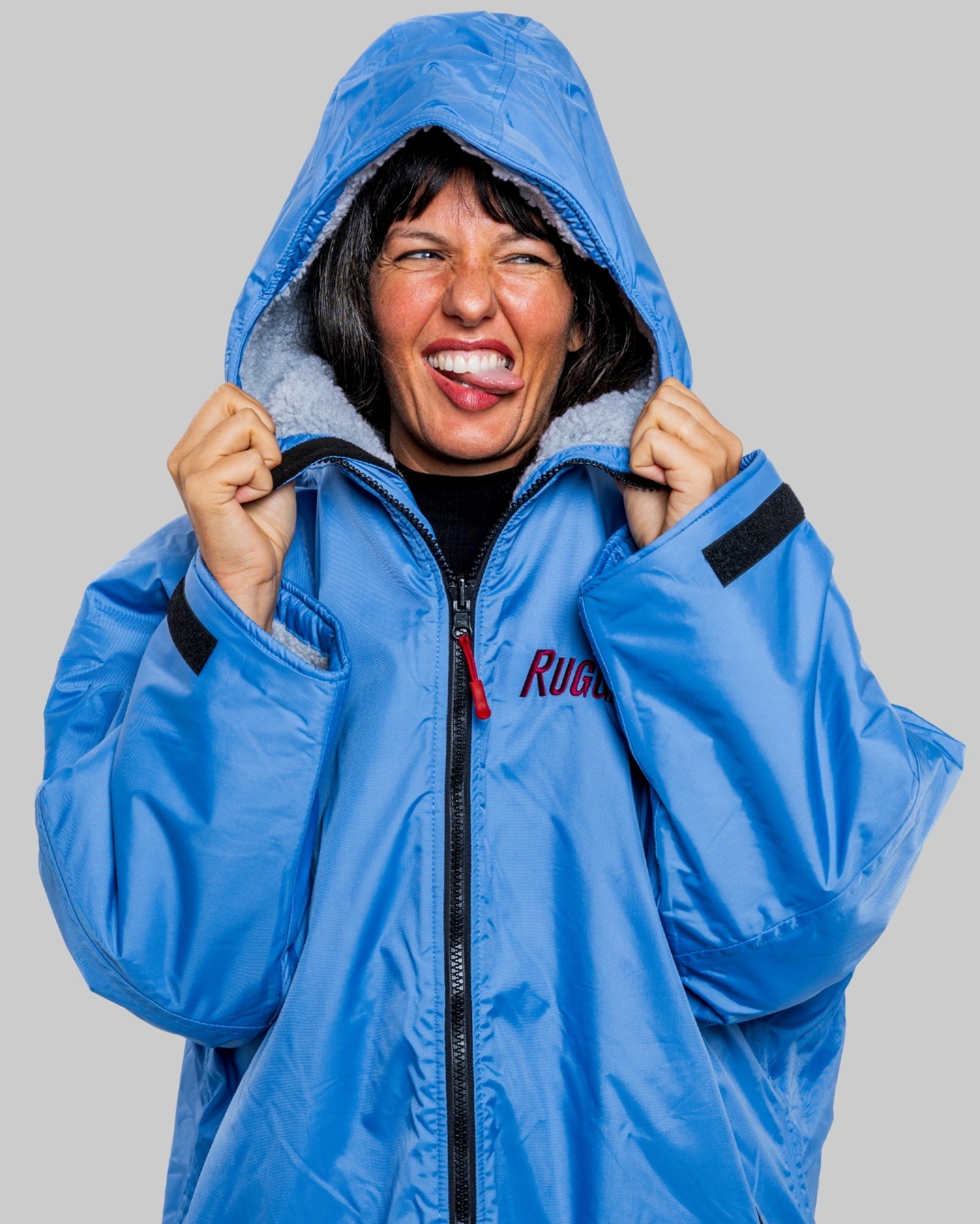 Model wearing a pale blue with grey feece  ruggarobe on a gray background