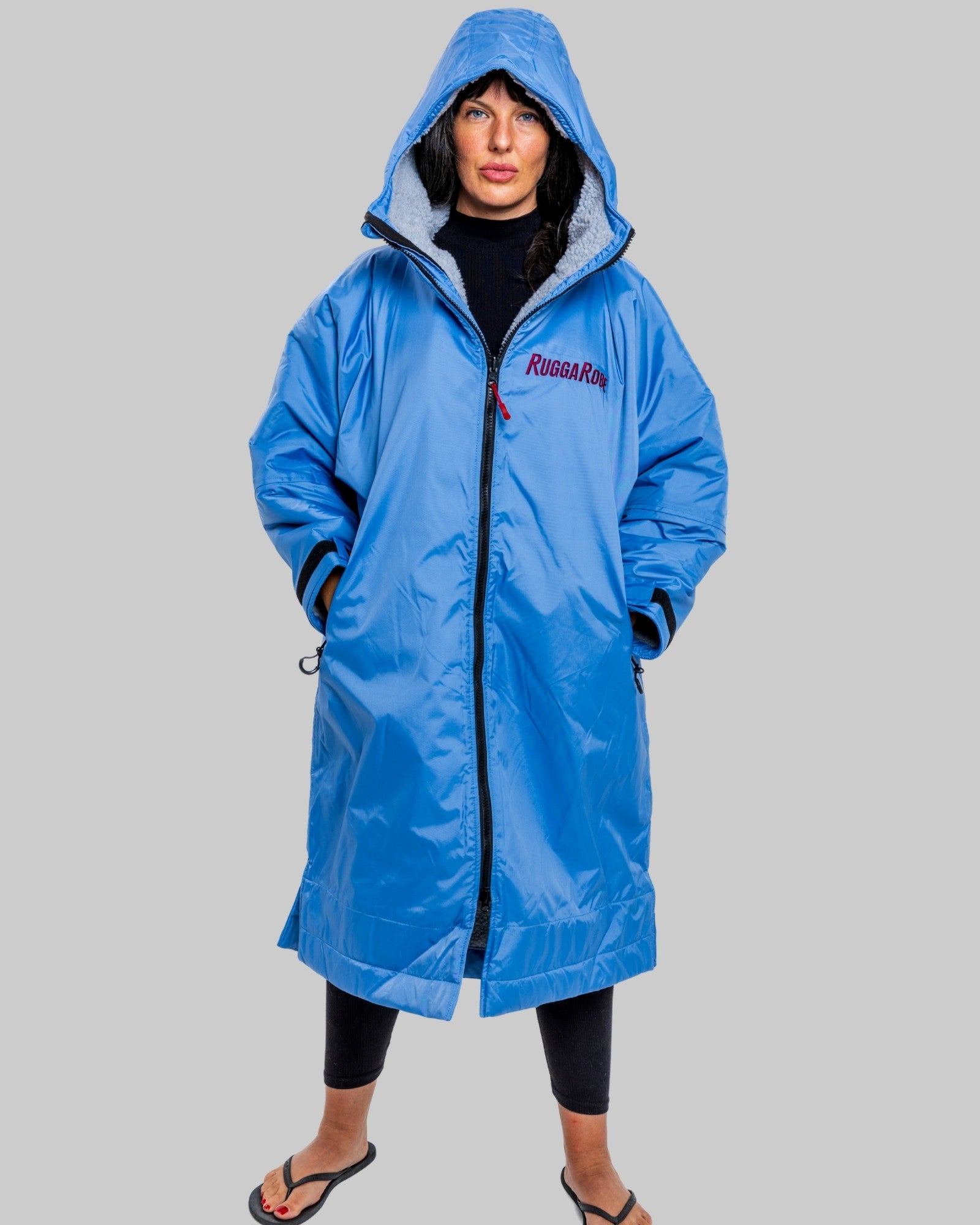 Model wearing a pale blue with grey feece  ruggarobe on a gray background