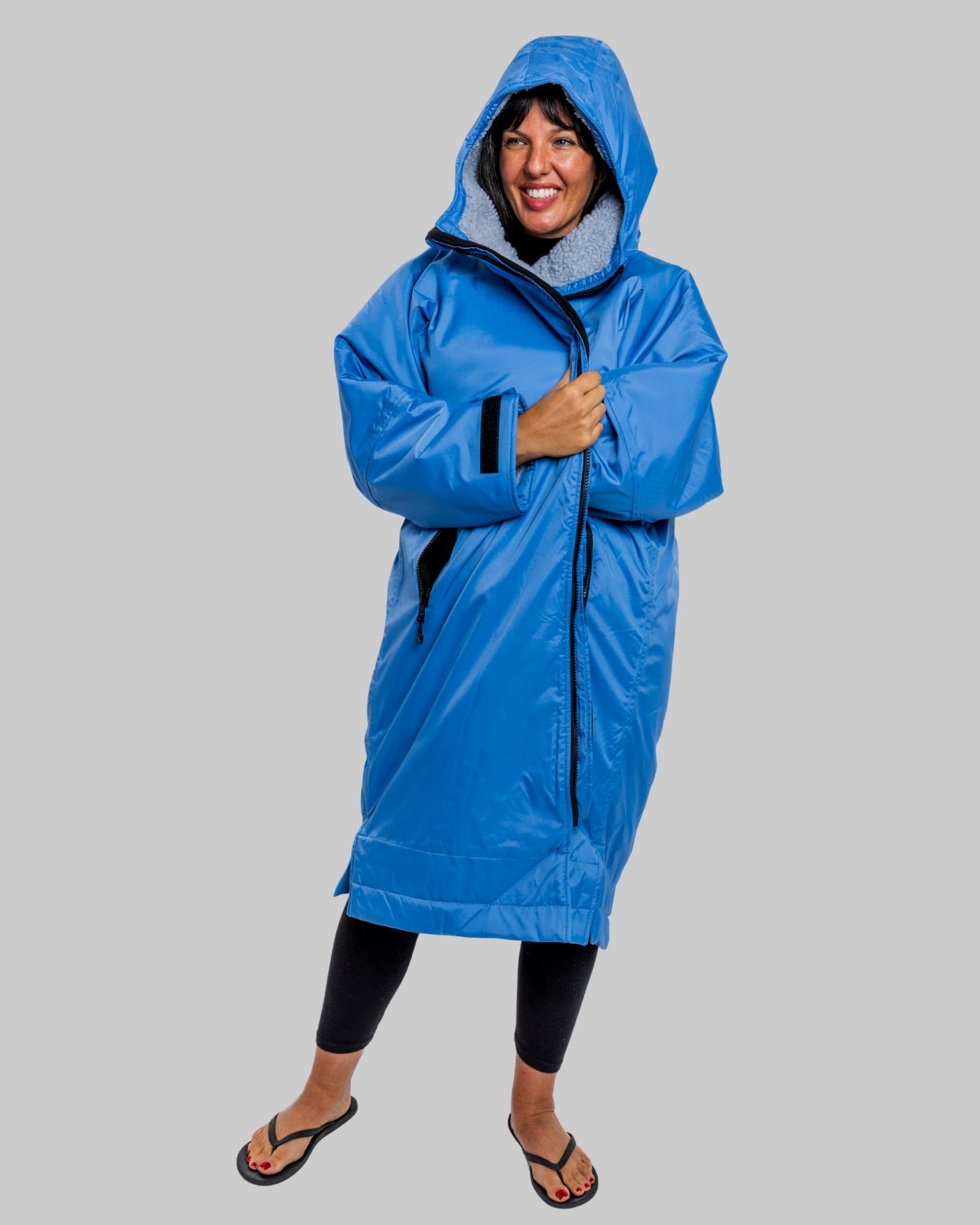 Model wearing a pale blue with grey fleece  ruggarobe on a gray background