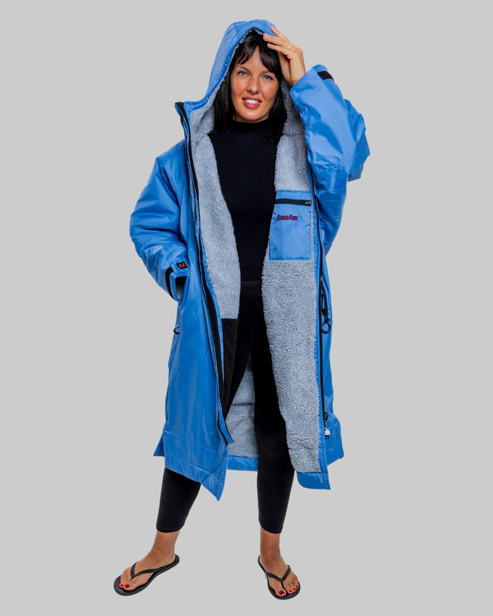 Model wearing a pale blue with grey feece  ruggarobe on a gray background