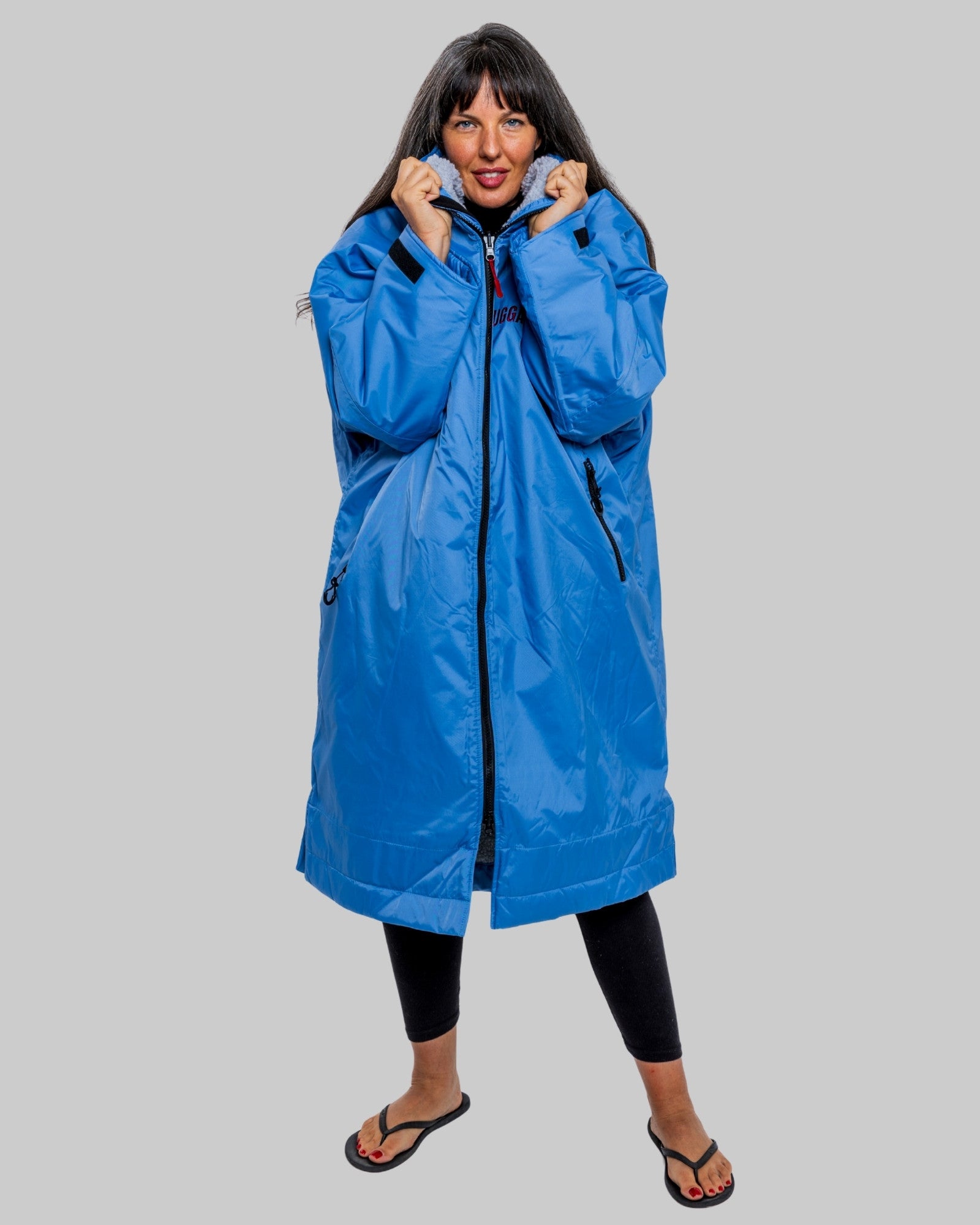 Model wearing a pale blue with grey feece  ruggarobe on a gray background