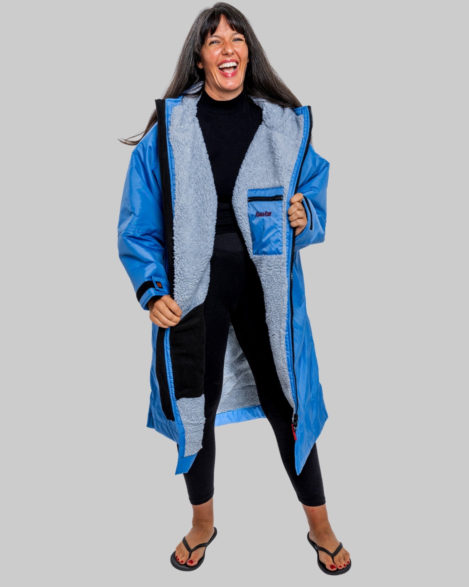 Model wearing a pale blue with grey feece  ruggarobe on a gray background