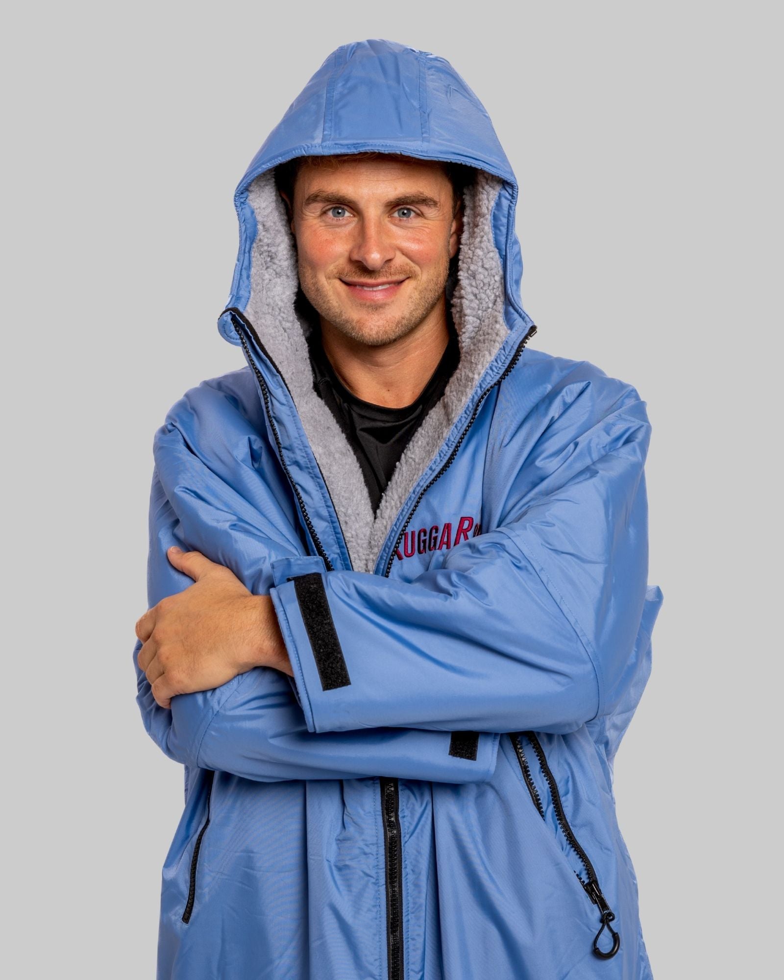 Model wearing a pale blue with grey feece  ruggarobe on a gray background