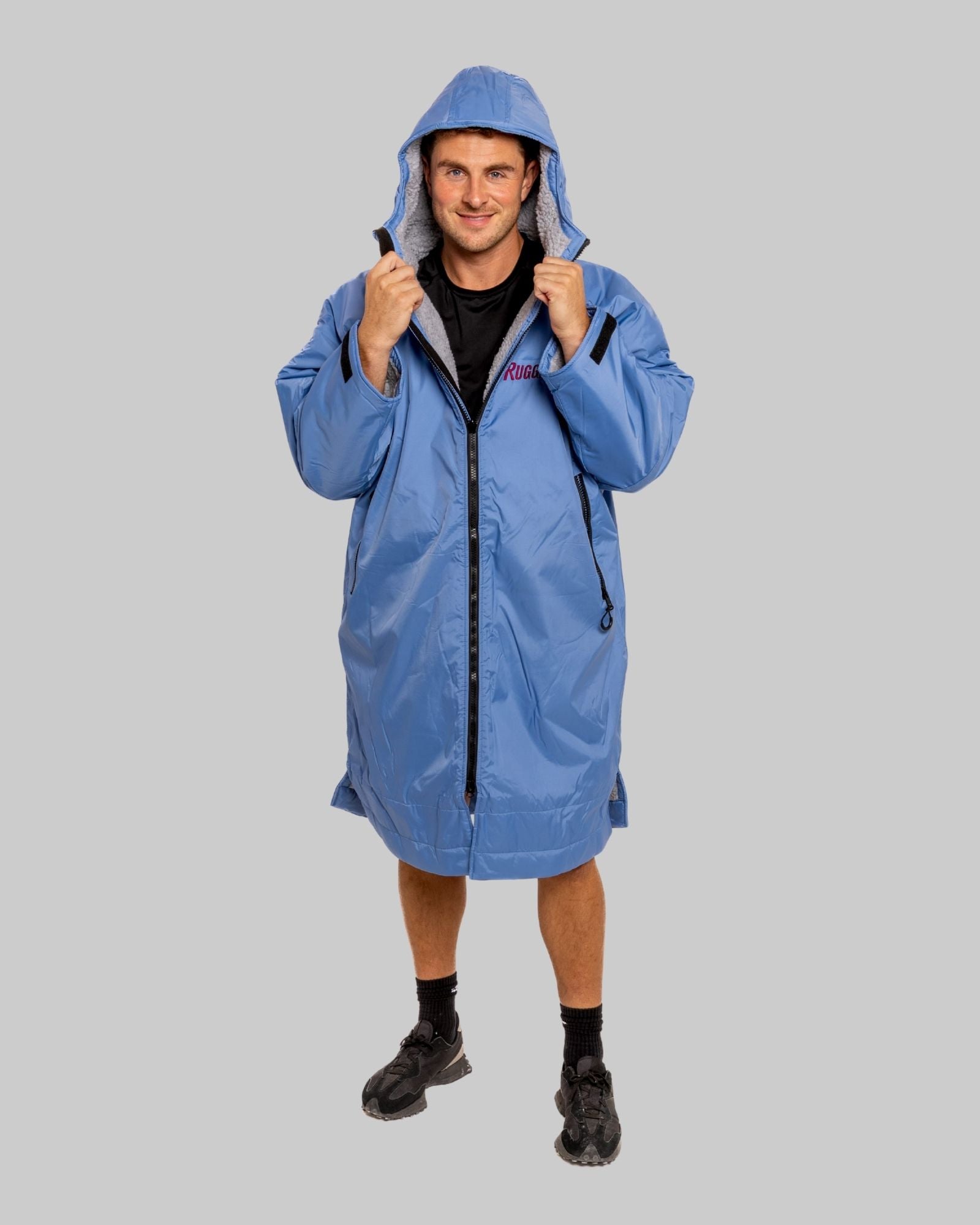 Model wearing a pale blue with grey feece  ruggarobe on a gray background