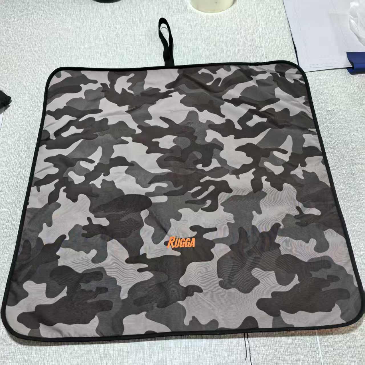 Rugga Robe camouflage-patterned mat with 'Rugga' branding on a light background