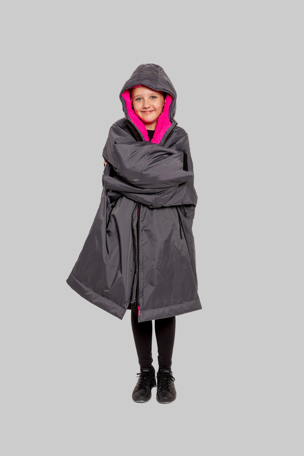 Model wearing RuggaRobe slate grey change robe with pink fleece interior on grey background