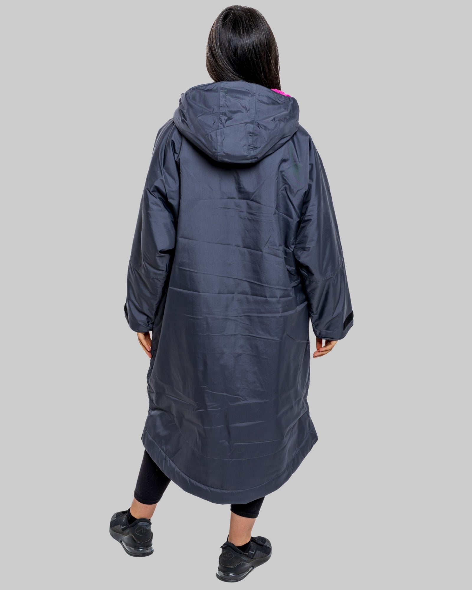 Model wearing RuggaRobe slate grey change robe with pink fleece interior on grey background